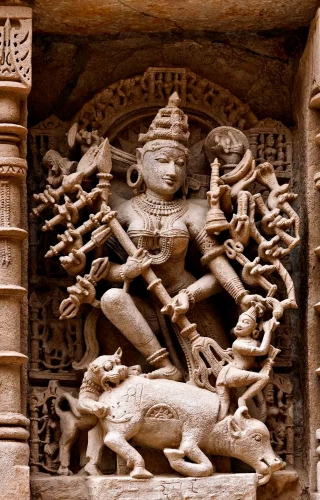 Perhaps the most intricate and well preserved Mahishasurmardini in India is this carving from the Ran-ki-Vav stepwell in Patan, Gujarat. The step well, constructed in the 11th century by Solanki Queen Udayamati, was designated by UNESCO as a World Heritage Site in 2014. The construction of step wells, called vav (also wav) or baoli in western India, formed a very important part of royal projects and philanthropy, in providing drinking water to citizens and along trade routes. These wells also offered a place for rest and prayers. In Hinduism, water has always been considered sacred, therefore step wells were constructed like inverted temples with a profusion of sculptures of gods and goddesses from the brahmanical pantheon and stories from the Hindu epics. This Mahishasurmardini is notable for the deep carving, making the statue almost three dimensional. Durga is holding Mahishasura by his hair as he emerges from the decapitated buffalo.